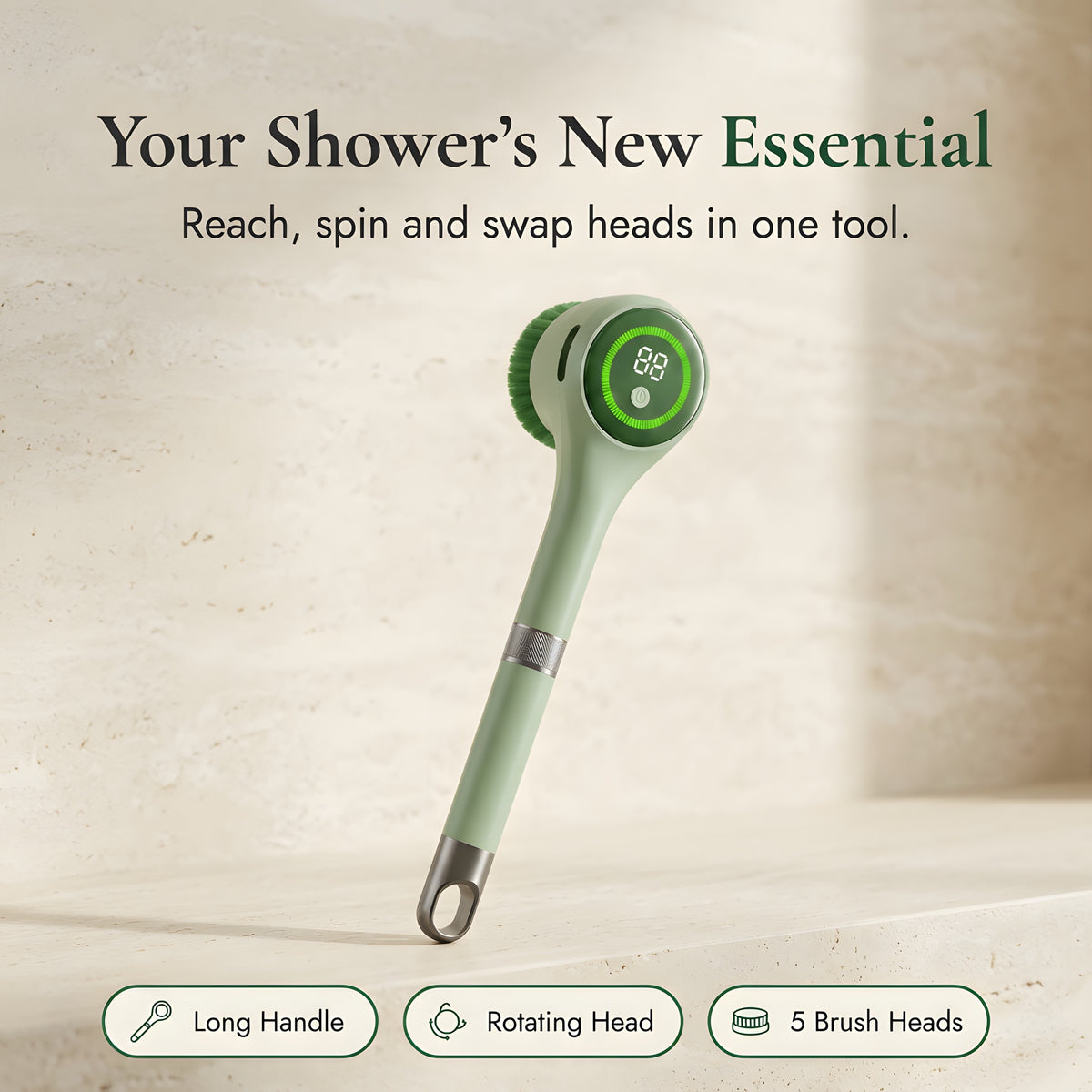 Sage green electric long-handle body scrubber with metal hanging loop on a warm stone background