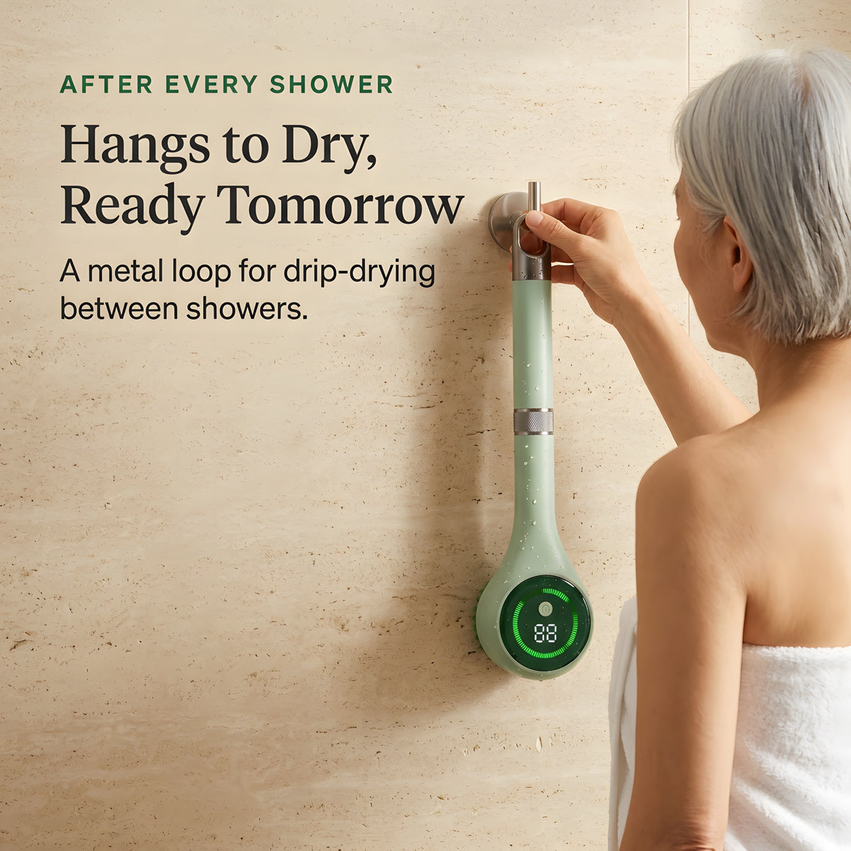 Electric scrubber hanging by its metal loop on a shower hook to drip-dry after use