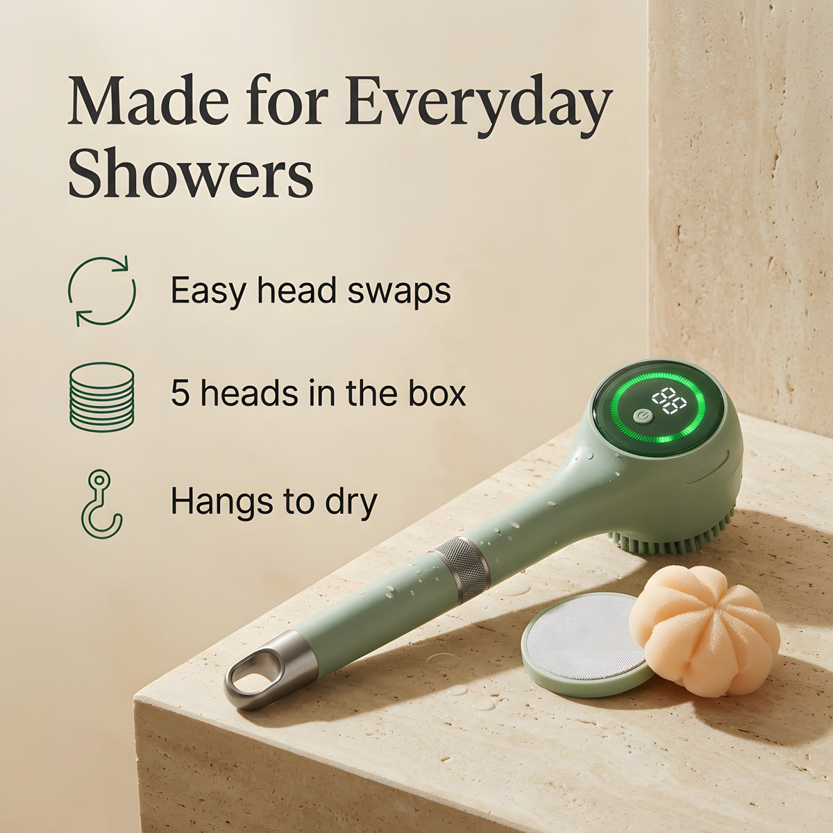 Electric body scrubber on a stone ledge with pumice pad and bubble sponge