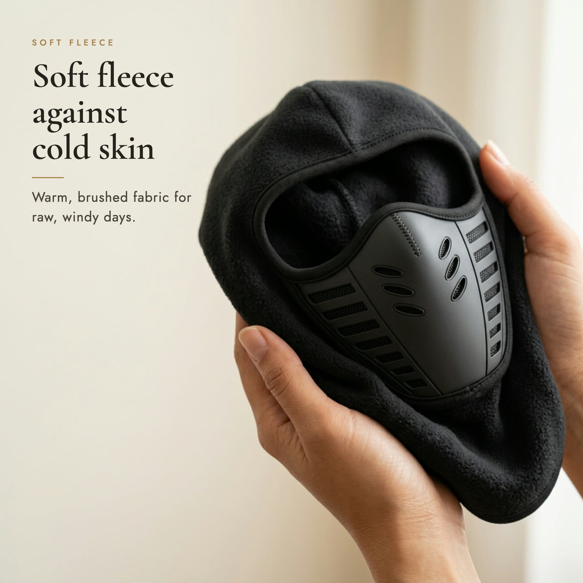 Hands holding the balaclava to show its soft brushed fleece, headline Soft fleece against cold skin